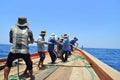 Fishermen are catching tuna with a trawl net.