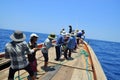 Fishermen are catching tuna with a trawl net.