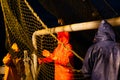 Fishermen choose a trawl with fish the ship