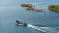 Fishermen in the Curonian Lagoon go fishing by motor boat. Fishing in nets in the lagoon, fishing for bream, starlings and perch. Royalty Free Stock Photo