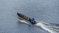 Fishermen in the Curonian Lagoon go fishing by motor boat. Fishing in nets in the lagoon, fishing for bream, starlings and perch. Royalty Free Stock Photo