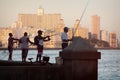 Fishermen at dawn on the famous Malecon seawall in Havana Royalty Free Stock Photo