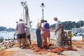 Fishermen with driftnet on dock in Rovinj