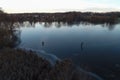 Fishermen on first ice on river.Thin river ice with reflections Royalty Free Stock Photo