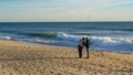 Fishermen fishing on beach at Faro, Algarve, Portugal.