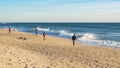 Fishermen fishing on beach at Faro, Algarve, Portugal.