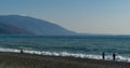 Fishermen are fishing in Black Sea. View of Caucasian mountains in Abkhazia from Russian side. December winter sea