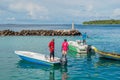 Fishermen fishing in the boats at the harbor at the tropical island in the ocean