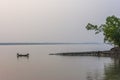 Fishermen fishing on a country boat in the dusk, on a river, in Bangladesh Sundarbans