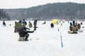 Fishermen fishing on a frozen lake in winter Royalty Free Stock Photo