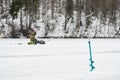 Fishermen fishing on a frozen lake in winter Royalty Free Stock Photo