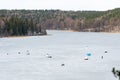 Fishermen fishing on a frozen lake in winter Royalty Free Stock Photo