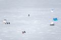 Fishermen fishing on a frozen lake in winter Royalty Free Stock Photo