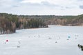 Fishermen fishing on a frozen lake in winter Royalty Free Stock Photo