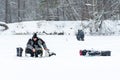 Fishermen fishing on a frozen lake in winter Royalty Free Stock Photo