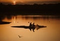 Fishermen fishing on lake with sunset behind Royalty Free Stock Photo