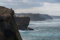 Fishermen fishing in Praia de Aljezur beach sea cliff edge, in Portugal Royalty Free Stock Photo