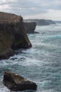 Fishermen fishing in Praia de Aljezur beach sea cliff edge, in Portugal Royalty Free Stock Photo