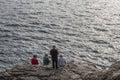 Fishermen fishing on rock