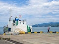 Fishermen are fishing with rods in the port area. People go fishing next to a moored ship. Hobbies for men. Life in a port city