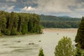 Fishermen fishing for salmon on the Skeena River below Terrace, during a cloudy day in summer, in British Columbia, Canada