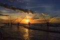 Fishermen fishing in the sea at sunrise Royalty Free Stock Photo