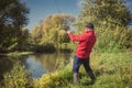 Fishermen fishing with a spinning rod from the shore on a sunny day. Fishing on a sunny day. Man on the river bank throws a Royalty Free Stock Photo