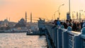 Fishermen on Galata bridge, fishing with their fishing poles during sunset, Karakoy, Galata bridge, Istanbul Royalty Free Stock Photo