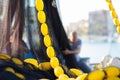 Fishermen in the harbor. In the foreground a black fishing net with floats. Royalty Free Stock Photo