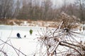 Fishermen on the ice, winter fishing, frozen pond