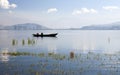 Fishermen on Lake in front of City