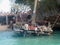 Fishermen near the shore prepare their wooden boat boat for swimming and fishing. Lifestyle of marine life of poor countries Royalty Free Stock Photo