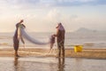 Fishermen with net on beach Royalty Free Stock Photo