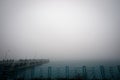 Fishermen on an old reinforced concrete  pier on a cloudy day Royalty Free Stock Photo