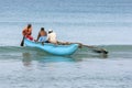 Fishermen paddle an outrigger canoe at Uppuveli in Sri Lanka.