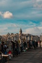 Fishermen and people on the Galata Bridge and Galata Tower on background. Royalty Free Stock Photo