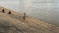 Fishermen Phnom Penh river fishing pole Royalty Free Stock Photo