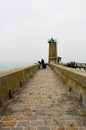 Fishermen on pier near a beacon light Royalty Free Stock Photo