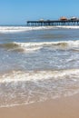 Fishermen pier, sand and waves Royalty Free Stock Photo