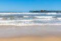 Fishermen pier, sand and waves Royalty Free Stock Photo