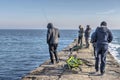 Fishermen on the pier by the sea Royalty Free Stock Photo