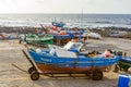 Fishermen prepare the old wooden fishing boat for the next turn in Famara