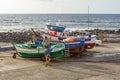 Fishermen prepare the old wooden fishing boat for the next turn in Famara