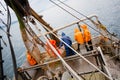 Fishermen in protective suits on deck Fishing vessel