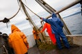 Fishermen in protective suits on deck Fishing vessel