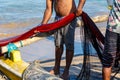 Fishermen with red nets on the shore of the ocean, Galle Sri Lanka Royalty Free Stock Photo