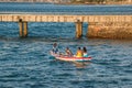 Fishermen and Religious Faithful in a rowing boat at Ponta de Humaita in Salvador, Brazil