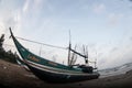 Fishermen remove fish from fishing nets at the beach