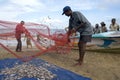 Fishermen remove fish from their nets after returning from a nights fishing off Negombo in Sri Lanka. Royalty Free Stock Photo