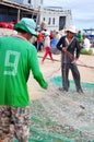 Fishermen are removing anchovies fish from their nets to start a new working day in Ly Son island Royalty Free Stock Photo